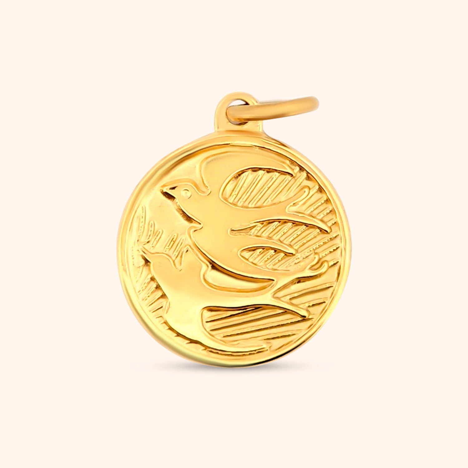 Close-up of the Skydancer Charm, a circular gold charm featuring an engraved bird design.